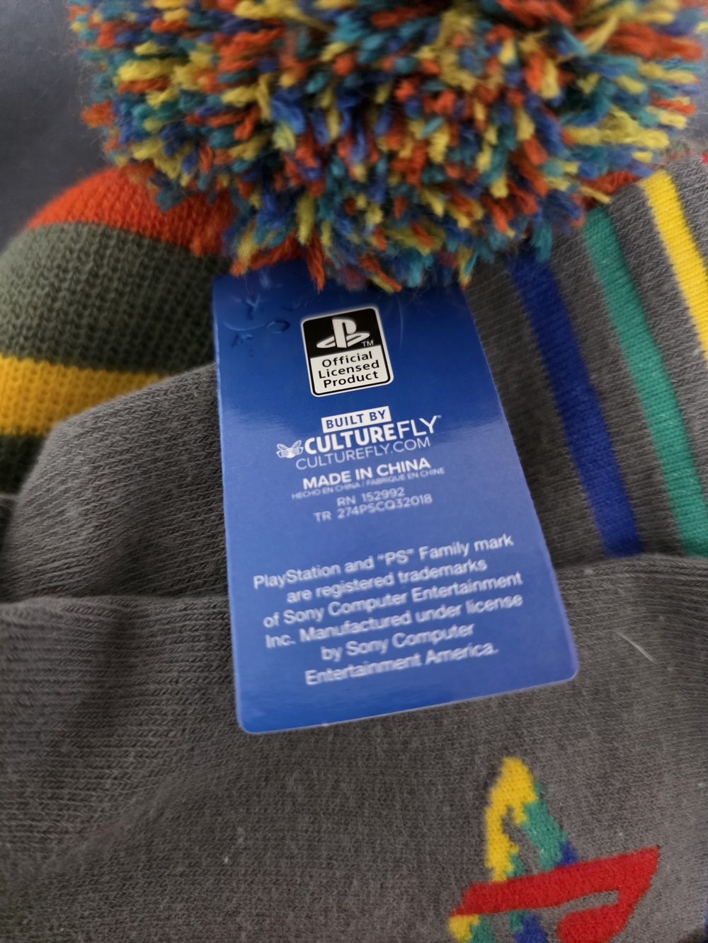 PlayStation Licensed Gray Knit Hat with Multicolor Stripes and Pom
